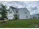Charming two-story home featuring a well-maintained lawn, attached garage, and classic architectural details at 110 Silver Oak Cir, Rockwell, NC 28138