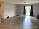 Spacious living room featuring wood-look floors, sliding glass doors, and contemporary design at 110 Silver Oak Cir, Rockwell, NC 28138