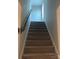 Staircase with carpeted steps, wooden handrail, and a light-filled landing at 110 Silver Oak Cir, Rockwell, NC 28138
