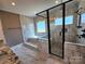 This bathroom features marble tiling, a glass shower, a soaking tub, and a dual vanity at 3251 Wilson Ct # 10, Lincolnton, NC 28092