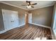 Neutral-toned bedroom with a ceiling fan, closet, and wood-look flooring creating a cozy and stylish space at 3251 Wilson Ct # 10, Lincolnton, NC 28092