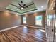 Primary bedroom featuring tray ceilings, recessed lighting, and wood-look floors, offering a luxurious retreat at 3251 Wilson Ct # 10, Lincolnton, NC 28092