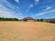 New construction home featuring a brick facade under a blue sky and ample yard space awaiting landscaping at 3251 Wilson Ct # 10, Lincolnton, NC 28092