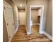 Home entryway hallway featuring hardwood floors and mudroom with white cabinets at 3251 Wilson Ct # 10, Lincolnton, NC 28092