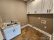 The laundry room features a slate floor, granite countertop, and overhead cabinets at 3251 Wilson Ct # 10, Lincolnton, NC 28092