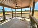The screened porch has a ceiling fan, wood railings, and a view of the yard at 3251 Wilson Ct # 10, Lincolnton, NC 28092