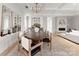 Bright dining room features an oval wooden table, chandelier, and built-in cabinetry at 130 Cherokee Rd # 404, Charlotte, NC 28207