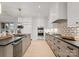 Modern kitchen with stone countertops and a geometric backsplash at 130 Cherokee Rd # 404, Charlotte, NC 28207