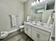 Modern bathroom with double vanity, large mirror, and gray flooring at 325 Jordan Ave, Spencer, NC 28159