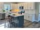 Modern kitchen featuring white cabinets, a center island, and stainless steel appliances at 325 Jordan Ave, Spencer, NC 28159