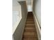 Carpeted staircase with white railings leading to the second floor at 1303 Dodd St, Shelby, NC 28152