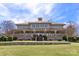 Stately clubhouse featuring stone accents, a covered porch, and expansive windows overlooking manicured grounds at 120-C Deer Brook Dr, Shelby, NC 28150