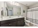 Modern bathroom features double sinks with white countertops and dark wood cabinetry at 107 Gray Willow St, Mooresville, NC 28117