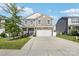 Two-story home featuring stone accents, a two-car garage, and a well-manicured lawn in a suburban neighborhood at 107 Gray Willow St, Mooresville, NC 28117