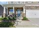 Inviting front porch with stone details, a stylish front door, and manicured landscaping at 107 Gray Willow St, Mooresville, NC 28117