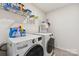 Functional laundry room with modern washer and dryer, shelving for storage and lots of supplies at 107 Gray Willow St, Mooresville, NC 28117