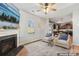 Cozy living room featuring a fireplace, comfortable seating, and a view into the adjacent kitchen at 107 Gray Willow St, Mooresville, NC 28117