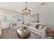 Bright, virtually staged living room with white couch, wood floors, and stylish decor at 107 Gray Willow St, Mooresville, NC 28117