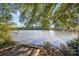 Picturesque waterfront view of the lake with natural shoreline and a bridge in the distance at 107 Gray Willow St, Mooresville, NC 28117