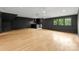 Large basement with wood floors, recessed lighting, bar area, and natural light from the window at 4142 Pineview Rd, Charlotte, NC 28211