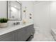 Bathroom with modern vanity, framed mirror, and patterned marble floor at 4142 Pineview Rd, Charlotte, NC 28211