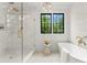 Bright bathroom with a soaking tub and a glass enclosed shower featuring gold fixtures at 4142 Pineview Rd, Charlotte, NC 28211