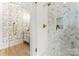 Elegant bathroom with herringbone shower tiles, glass door, gold fixtures, and decorative wallpaper at 4142 Pineview Rd, Charlotte, NC 28211
