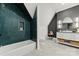 Modern bathroom with a sleek vanity, stylish mirror, and beautiful tile work around the tub at 4142 Pineview Rd, Charlotte, NC 28211