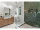 Beautiful bathroom with a glass shower, wood vanity, and stylish fixtures at 4142 Pineview Rd, Charlotte, NC 28211