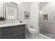 Modern bathroom featuring a vanity with silver hardware, quartz countertop, and tile shower at 4142 Pineview Rd, Charlotte, NC 28211