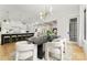 Open concept dining room with modern lighting adjacent to the kitchen and living room at 4142 Pineview Rd, Charlotte, NC 28211