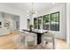 Bright dining room features a modern chandelier, black framed windows and wood flooring at 4142 Pineview Rd, Charlotte, NC 28211