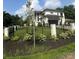 Beautiful exterior view of a two-story home with black trim, manicured lawn, black metal fence and flower bed at 4142 Pineview Rd, Charlotte, NC 28211