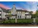 A beautiful two-story home showcasing detailed architectural design, manicured landscaping, and a secure perimeter fence at 4142 Pineview Rd, Charlotte, NC 28211