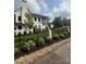 Beautiful two-story home with a brick exterior, manicured lawn, and black metal fence at 4142 Pineview Rd, Charlotte, NC 28211
