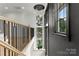 Upstairs hallway features hardwood floors, black trim windows, modern lighting and staircase at 4142 Pineview Rd, Charlotte, NC 28211