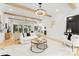 Open-concept living room featuring exposed wood beams, hardwood flooring, and ample natural light at 4142 Pineview Rd, Charlotte, NC 28211