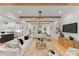Spacious living area with hardwood floors, exposed beams, and seamless flow into the modern kitchen at 4142 Pineview Rd, Charlotte, NC 28211