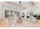 Open concept living room with wood beam ceiling open to kitchen and dining room at 4142 Pineview Rd, Charlotte, NC 28211