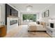 Airy main bedroom with hardwood floors, fireplace and black trim windows at 4142 Pineview Rd, Charlotte, NC 28211