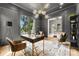 Chic office featuring dark gray walls, modern lighting, large windows, and contemporary furnishings at 4142 Pineview Rd, Charlotte, NC 28211