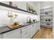 Well-organized pantry with open shelving, a countertop, cabinets and stylish decor elements at 4142 Pineview Rd, Charlotte, NC 28211