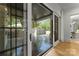 View through sliding glass doors to an outdoor patio with stone floor and wood columns at 4142 Pineview Rd, Charlotte, NC 28211