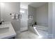 Serene bathroom features a soaking tub, marble tiled shower, modern fixtures, and neutral color palette for a luxurious feel at 1405 Coppergate Dr, Salisbury, NC 28147