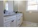 Bright bathroom with white cabinets, black hardware, granite countertop and large mirror at 1405 Coppergate Dr, Salisbury, NC 28147