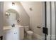 Bathroom features toilet and modern sink with a round mirror at 1405 Coppergate Dr, Salisbury, NC 28147