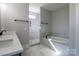 Well-lit bathroom featuring double sinks, soaking tub, and walk in shower at 1405 Coppergate Dr, Salisbury, NC 28147