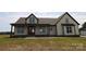 Attractive two-story home boasting a welcoming covered front porch, light siding, and elegant dark trim accents, adding to its appeal at 1405 Coppergate Dr, Salisbury, NC 28147
