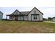 Charming two-story residence showcasing a covered porch, light-colored siding, and contrasting dark trim, providing a warm curb appeal at 1405 Coppergate Dr, Salisbury, NC 28147