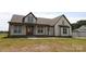 Inviting two-story home featuring a covered front porch, neutral siding, and contrasting dark trim, creating a charming curb appeal at 1405 Coppergate Dr, Salisbury, NC 28147